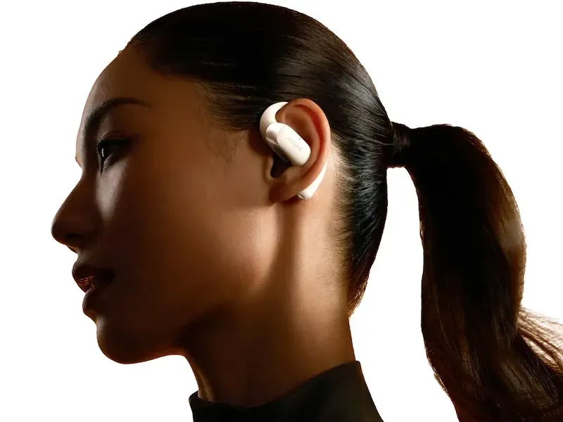 Shokz OpenFit 2 open-ear earbuds showing dual-driver design and ear hook structure
